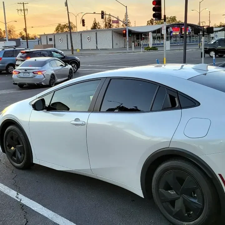 White 2023 Toyota Prius with freshly tinted windows, photographed after its tint job at King Auto Tint in Sacramento