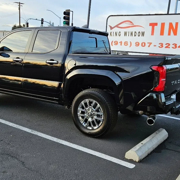 Black 2024 Toyota Tacoma with freshly tinted windows, in the King Window Tint parking lot on Fulton Avenue, Sacramento