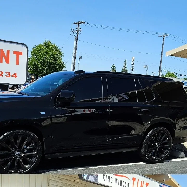 Black 2025 Cadillac Escalade with freshly tinted windows, in the King Window Tint parking lot on Fulton Avenue, Sacramento