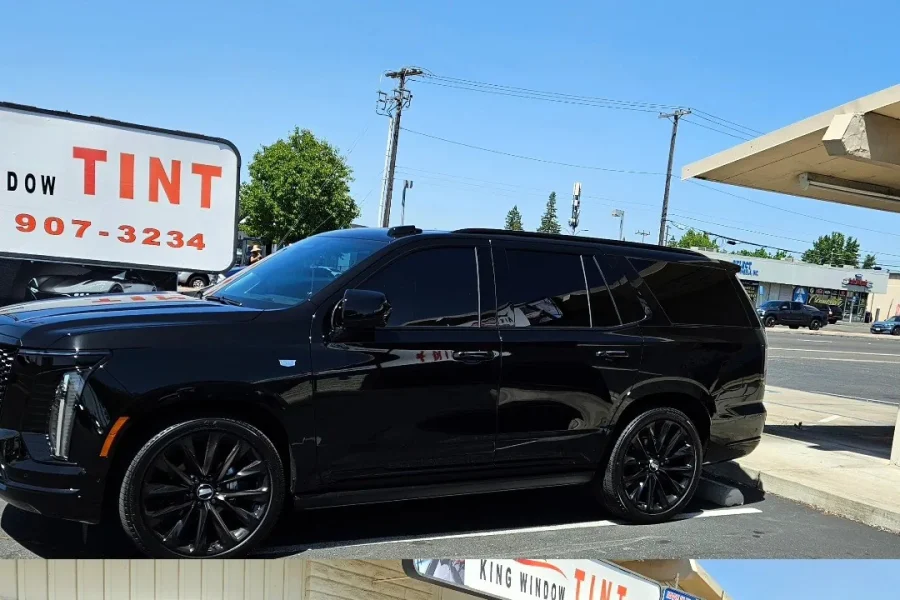 Black 2025 Cadillac Escalade with freshly tinted windows, in the King Window Tint parking lot on Fulton Avenue, Sacramento