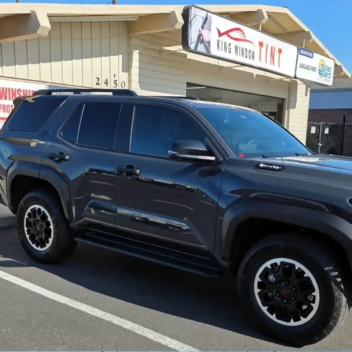 Dark gray 2025 Toyota 4Runner with freshly tinted windows, outside the King Window Tint shop on Fulton Ave in Sacramento