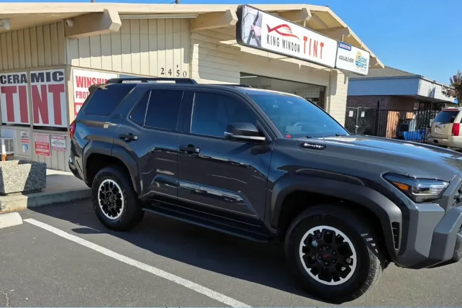 Dark gray 2025 Toyota 4Runner with freshly tinted windows, outside the King Window Tint shop on Fulton Ave in Sacramento