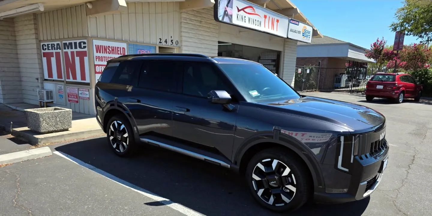Dark gray 2026 Kia Telluride with freshly tinted windows, parked in front of King Window Tint at 2450 Fulton Ave, Sacramento