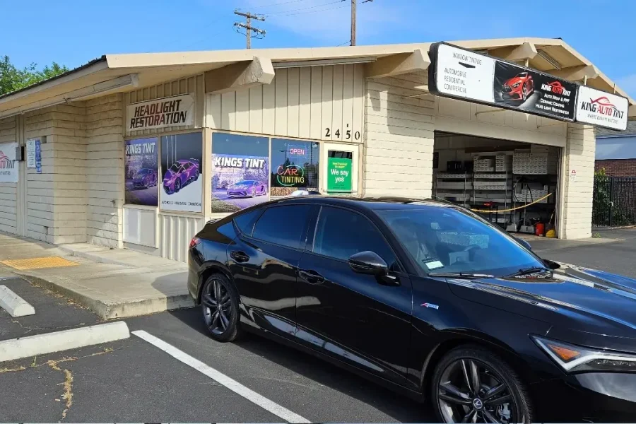 Black Acura Integra with freshly tinted windows, outside the King Auto Tint shop on Fulton Ave in Sacramento
