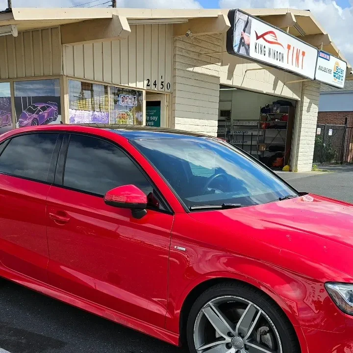 Red Audi A3 with freshly tinted windows, parked in front of King Window Tint at 2450 Fulton Ave, Sacramento