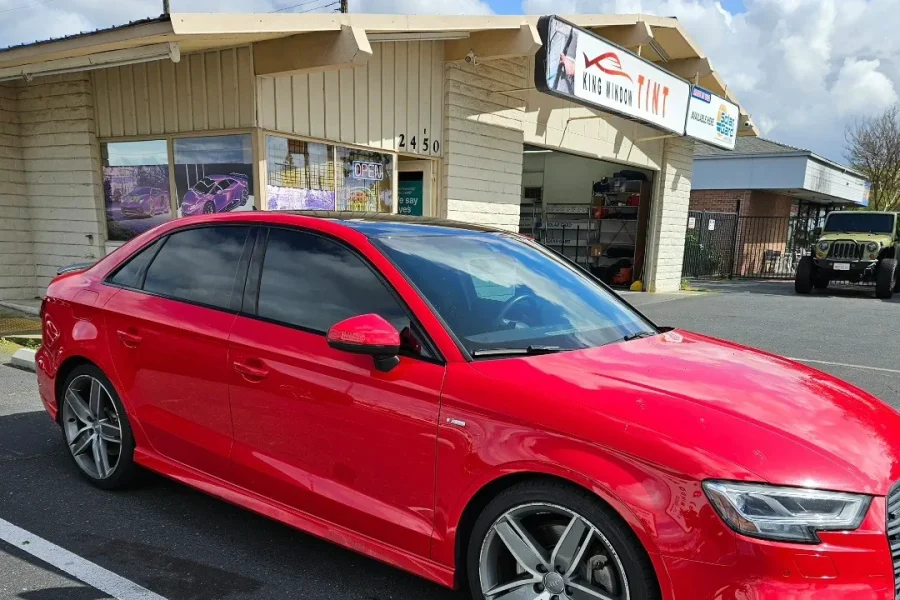 Red Audi A3 with freshly tinted windows, parked in front of King Window Tint at 2450 Fulton Ave, Sacramento