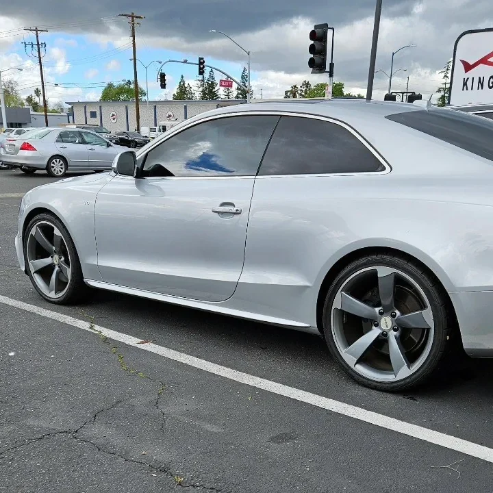 Silver Audi A5 with freshly tinted windows, in the King Window Tint parking lot on Fulton Avenue, Sacramento