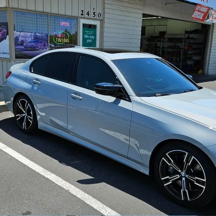 Silver BMW 3 Series with freshly tinted windows, in the King Window Tint parking lot on Fulton Avenue, Sacramento