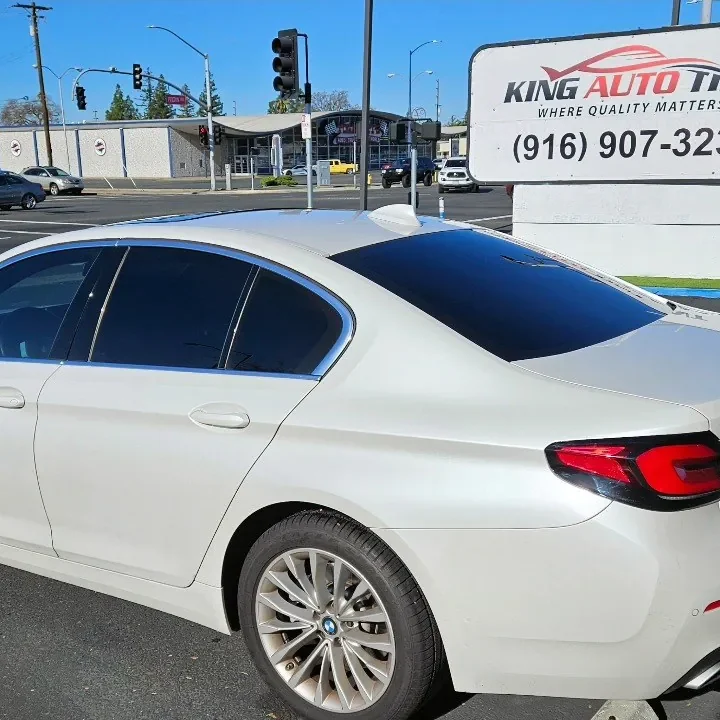 White BMW 5 Series with freshly tinted windows, photographed after its tint job at King Auto Tint in Sacramento