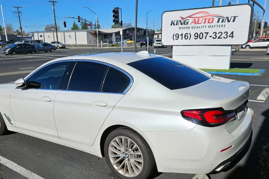 White BMW 5 Series with freshly tinted windows, photographed after its tint job at King Auto Tint in Sacramento
