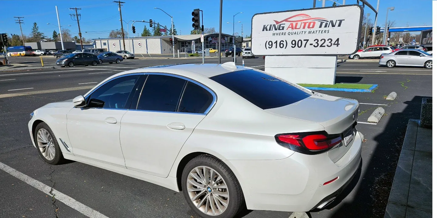 White BMW 5 Series with freshly tinted windows, photographed after its tint job at King Auto Tint in Sacramento