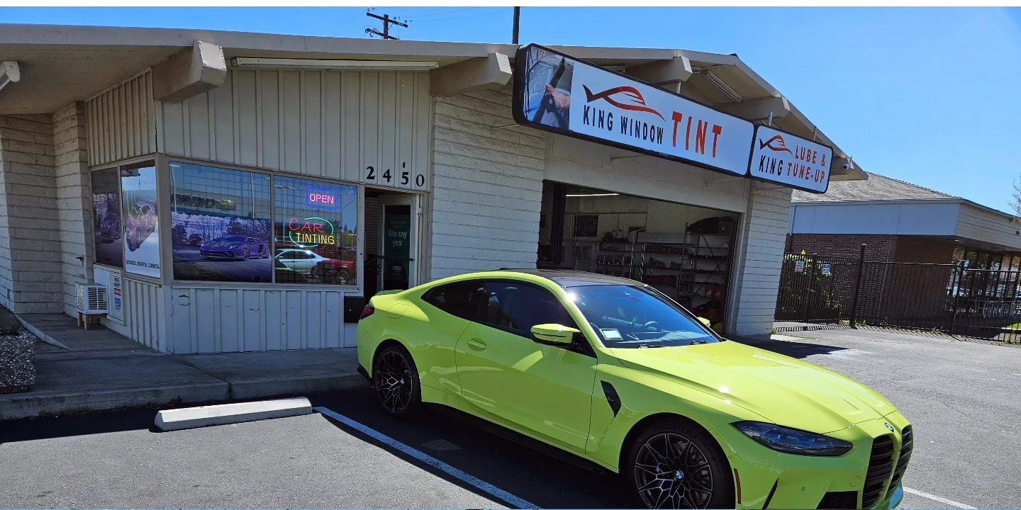 Lime yellow BMW M4 with freshly tinted windows, parked in front of King Window Tint at 2450 Fulton Ave, Sacramento
