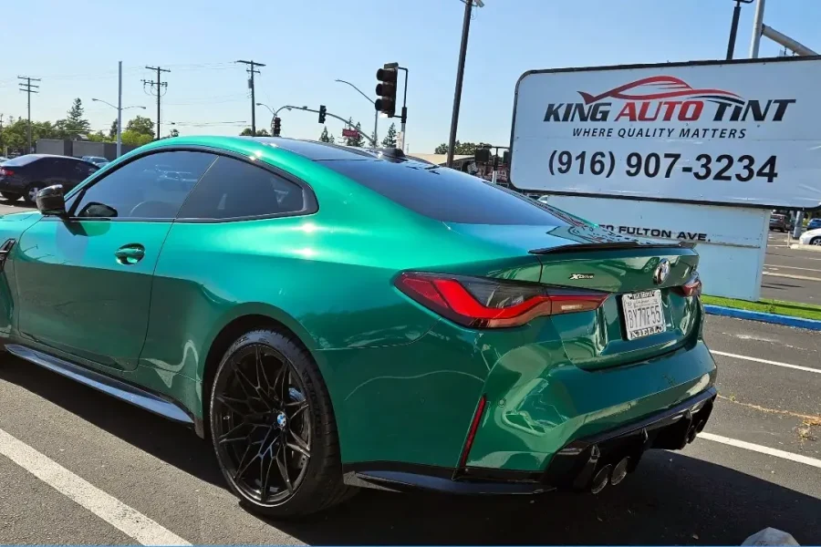 Green BMW M4 with freshly tinted windows, outside the King Auto Tint shop on Fulton Ave in Sacramento
