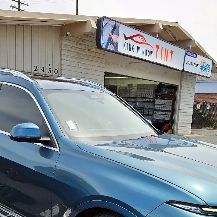 Blue BMW X7 with freshly tinted windows, parked in front of King Window Tint at 2450 Fulton Ave, Sacramento