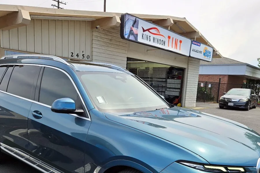 Blue BMW X7 with freshly tinted windows, parked in front of King Window Tint at 2450 Fulton Ave, Sacramento