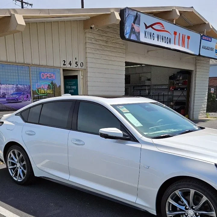 White Cadillac CT5 with freshly tinted windows, parked in front of King Window Tint at 2450 Fulton Ave, Sacramento