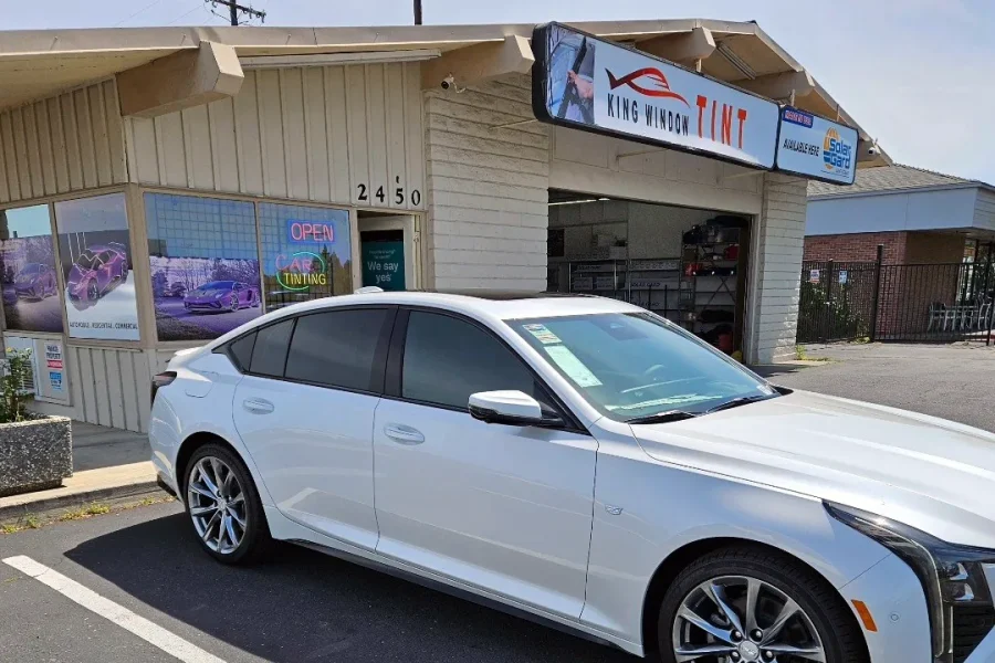 White Cadillac CT5 with freshly tinted windows, parked in front of King Window Tint at 2450 Fulton Ave, Sacramento