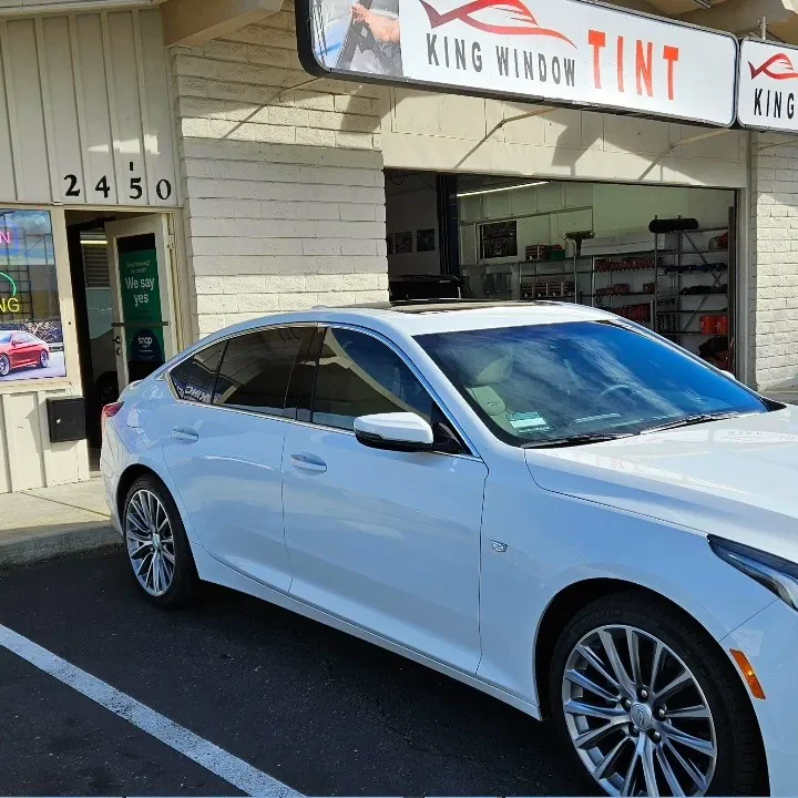 White Cadillac CT5 with freshly tinted windows, in the King Window Tint parking lot on Fulton Avenue, Sacramento