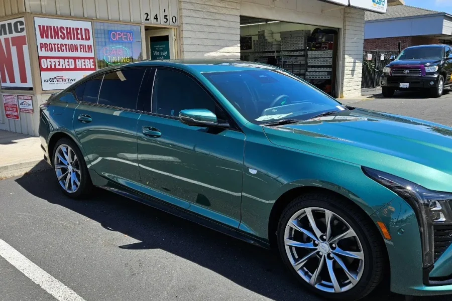 Green Cadillac CT5 with freshly tinted windows, parked in front of King Window Tint at 2450 Fulton Ave, Sacramento