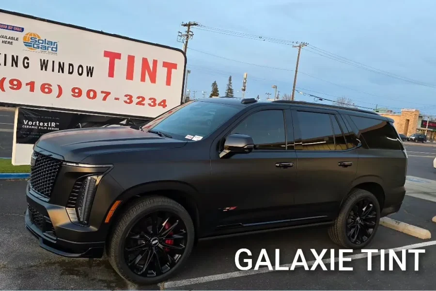 Matte black Cadillac Escalade-V with Galaxie window tint and matte black paint protection film, parked in front of King Window Tint at 2450 Fulton Ave, Sacramento