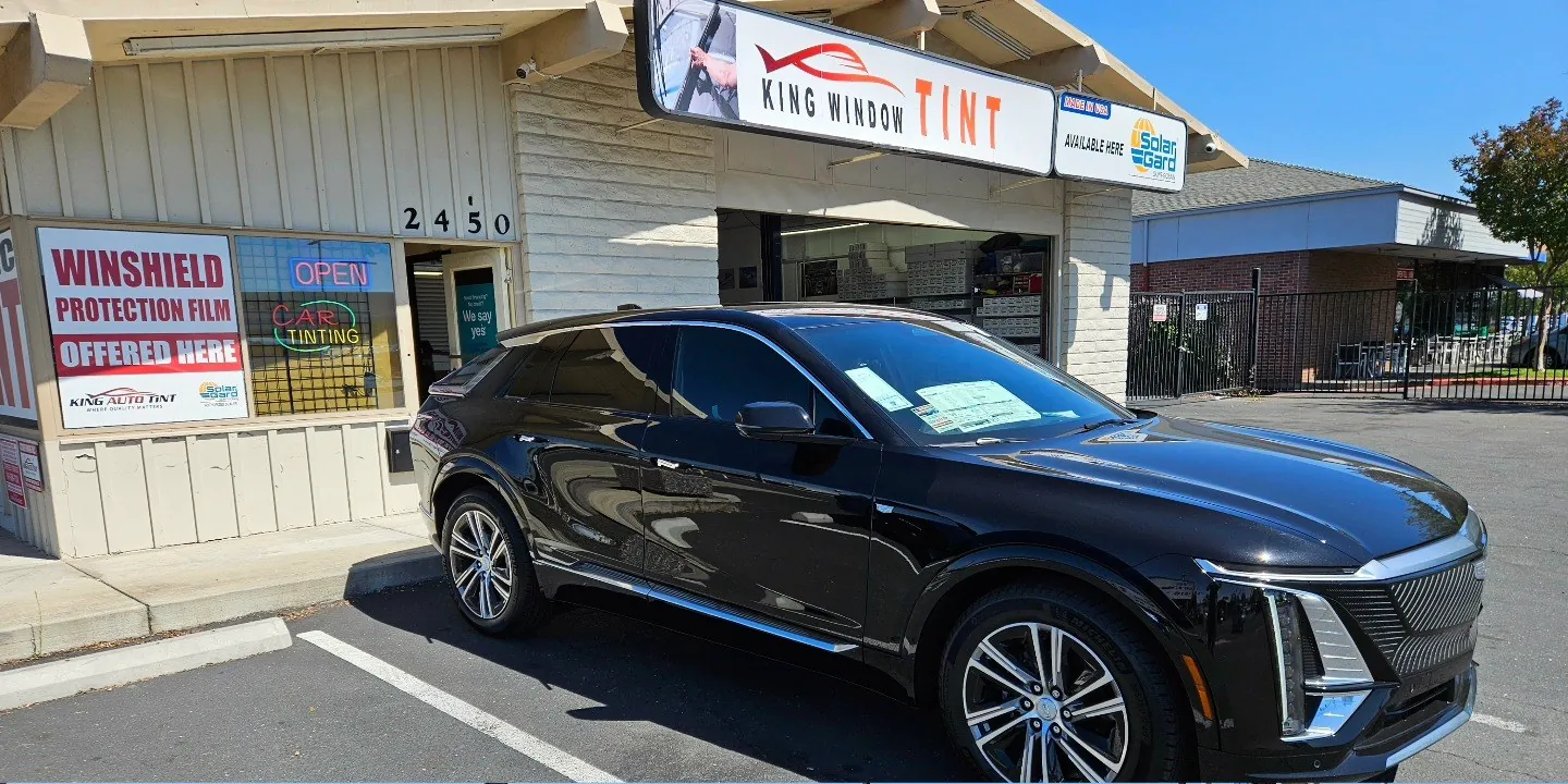 Two SUVs side by side outside King Auto Tint, one with carbon film and one with ceramic window film