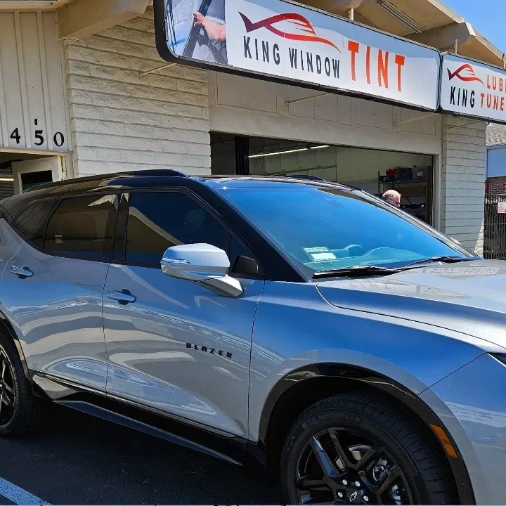 Silver Chevrolet Blazer with freshly tinted windows, in the King Window Tint parking lot on Fulton Avenue, Sacramento