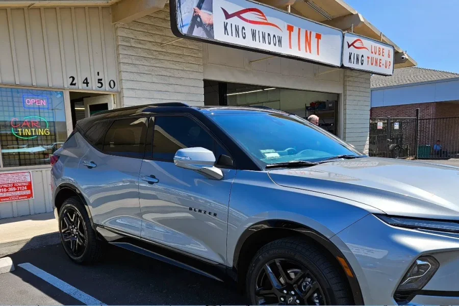 Silver Chevrolet Blazer with freshly tinted windows, in the King Window Tint parking lot on Fulton Avenue, Sacramento