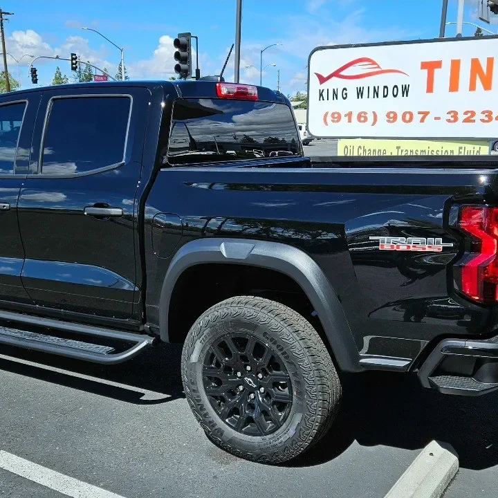 Black Chevrolet Colorado with freshly tinted windows, parked in front of King Window Tint at 2450 Fulton Ave, Sacramento