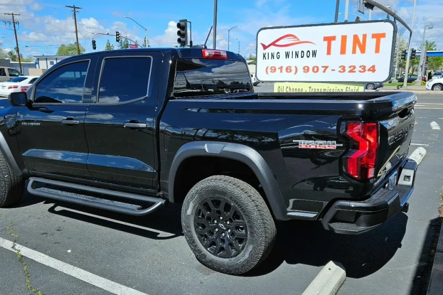 Black Chevrolet Colorado with freshly tinted windows, parked in front of King Window Tint at 2450 Fulton Ave, Sacramento