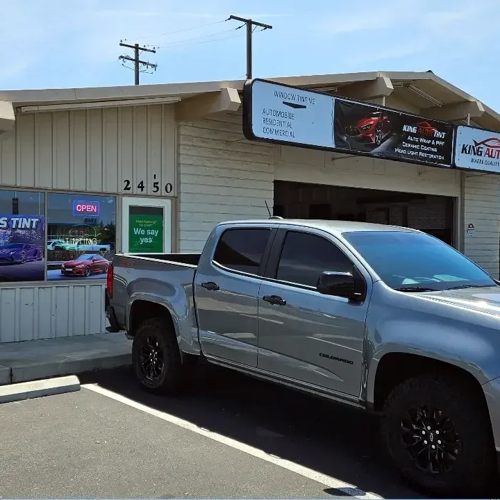 Gray Chevrolet Colorado with freshly tinted windows, in the King Auto Tint parking lot on Fulton Avenue, Sacramento