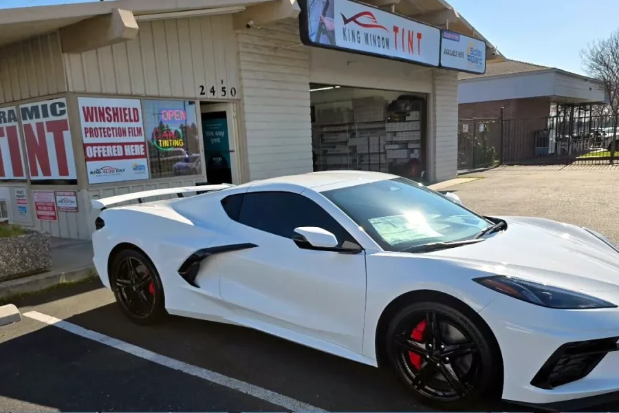 White Chevrolet Corvette Stingray with freshly tinted windows, in the King Window Tint parking lot on Fulton Avenue, Sacramento