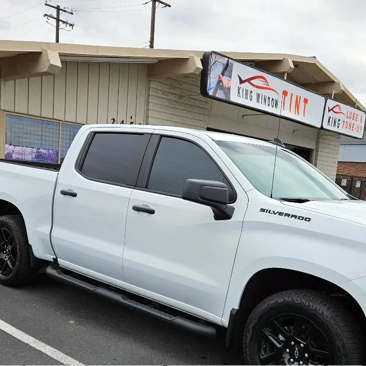 White Chevrolet Silverado 1500 with freshly tinted windows, in the King Window Tint parking lot on Fulton Avenue, Sacramento