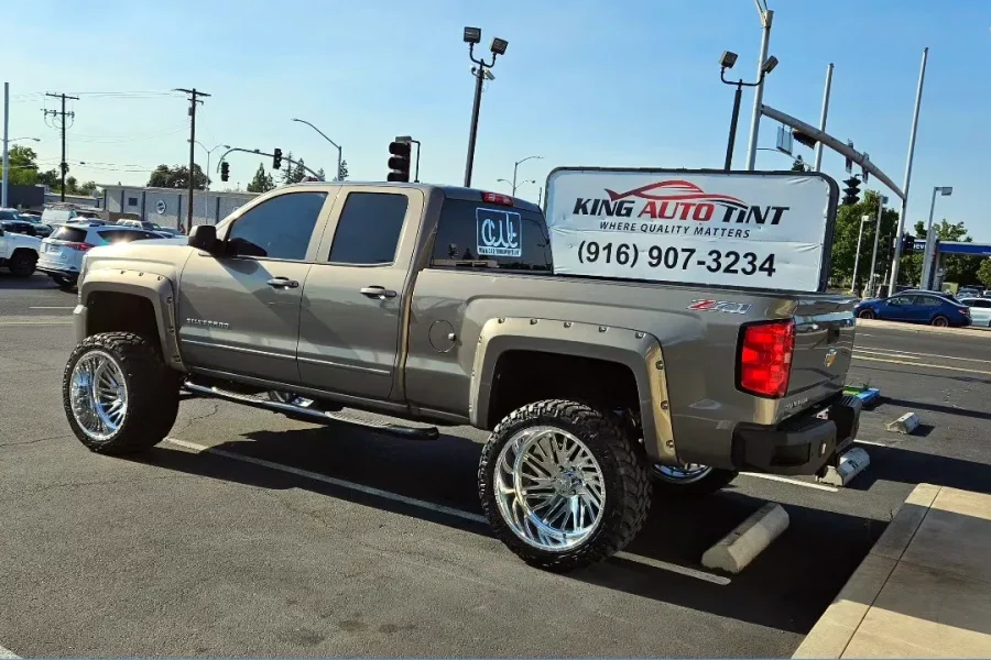 Bronze Chevrolet Silverado 1500 with freshly tinted windows, photographed after its tint job at King Auto Tint in Sacramento (lifted on chrome wheels)