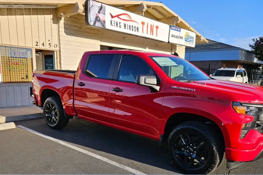 Red Chevrolet Silverado 1500 with freshly tinted windows, photographed after its tint job at King Window Tint in Sacramento