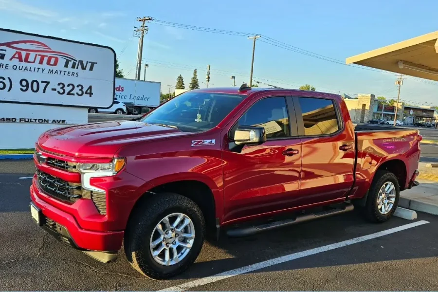 Red Chevrolet Silverado 1500 Z71 with freshly tinted windows, in the King Auto Tint parking lot on Fulton Avenue, Sacramento