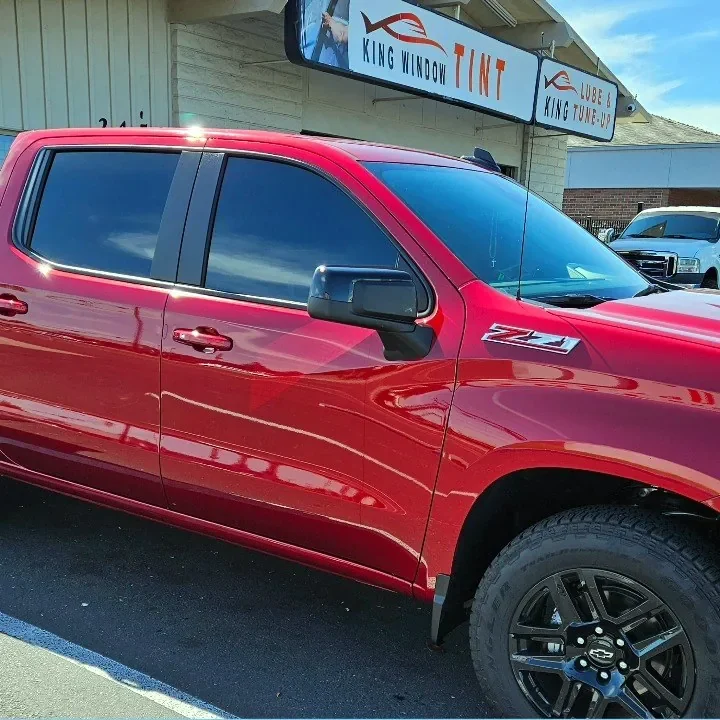 Red Chevrolet Silverado 1500 Z71 with freshly tinted windows, parked in front of King Window Tint at 2450 Fulton Ave, Sacramento