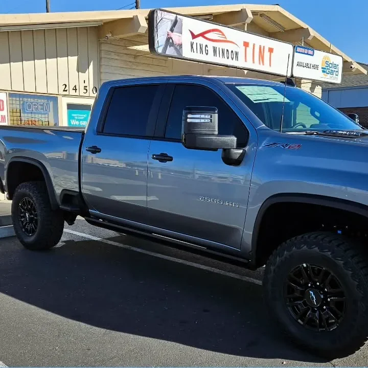 Gray Chevrolet Silverado 2500HD with freshly tinted windows, parked in front of King Window Tint at 2450 Fulton Ave, Sacramento