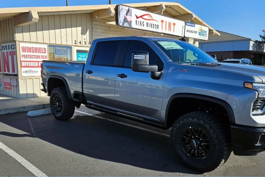 Gray Chevrolet Silverado 2500HD with freshly tinted windows, parked in front of King Window Tint at 2450 Fulton Ave, Sacramento