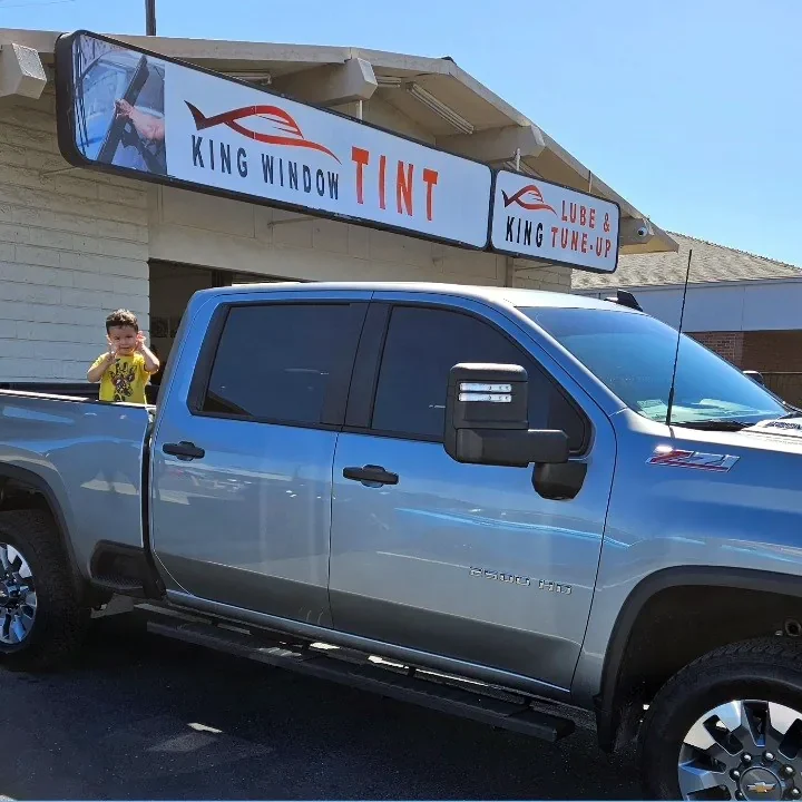 Silver Chevrolet Silverado 2500HD with freshly tinted windows, parked in front of King Window Tint at 2450 Fulton Ave, Sacramento