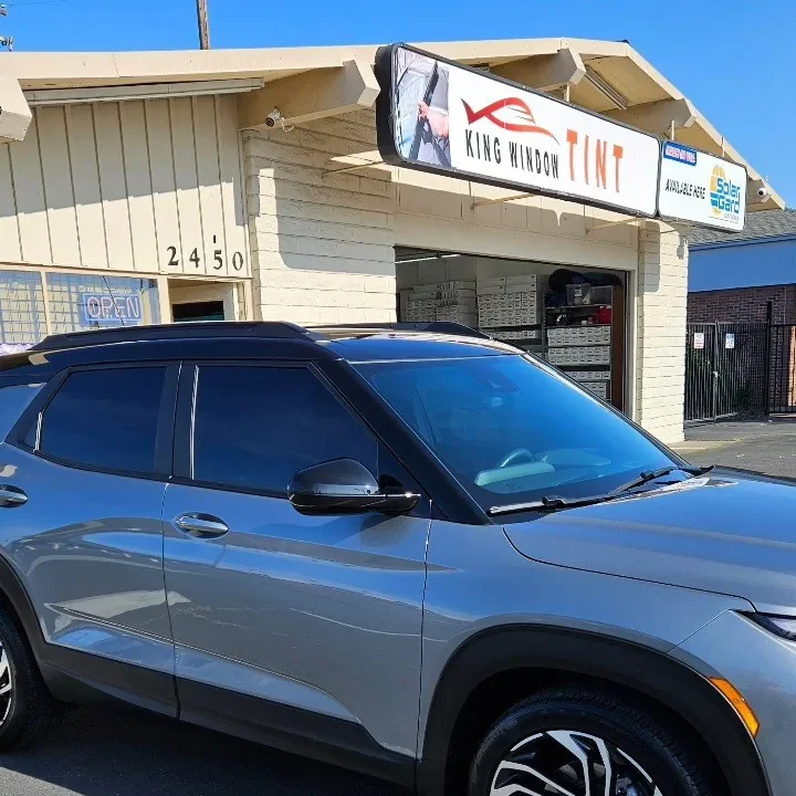 Silver Chevrolet Trailblazer with freshly tinted windows, outside the King Window Tint shop on Fulton Ave in Sacramento