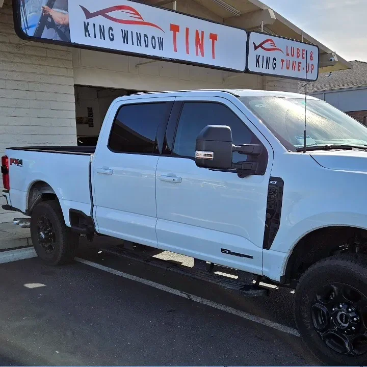 White Ford F-250 Super Duty with freshly tinted windows, outside the King Window Tint shop on Fulton Ave in Sacramento