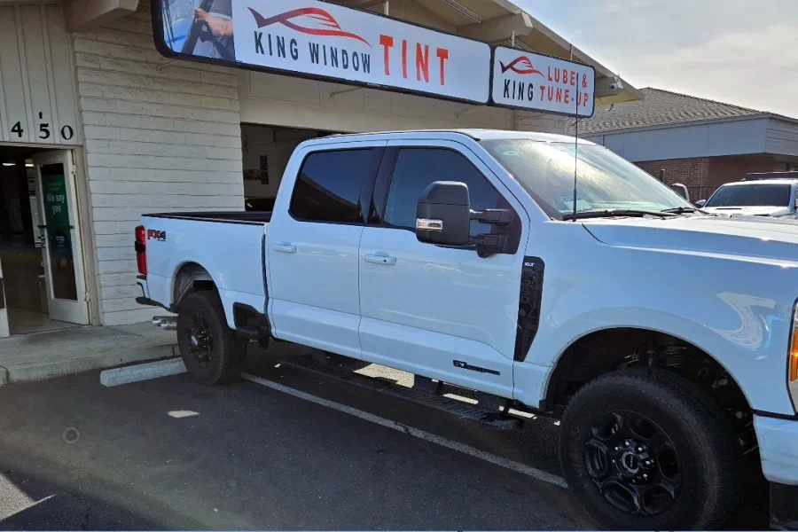 White Ford F-250 Super Duty with freshly tinted windows, outside the King Window Tint shop on Fulton Ave in Sacramento