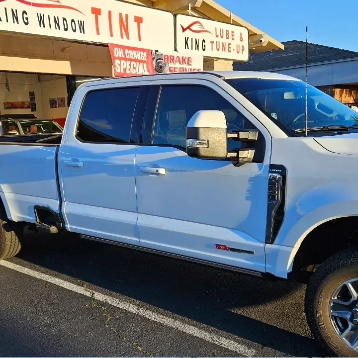 White Ford F-250 Super Duty with freshly tinted windows, in the King Window Tint parking lot on Fulton Avenue, Sacramento