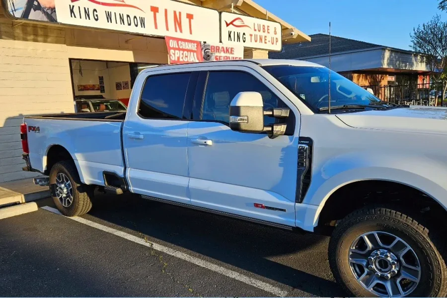 White Ford F-250 Super Duty with freshly tinted windows, in the King Window Tint parking lot on Fulton Avenue, Sacramento