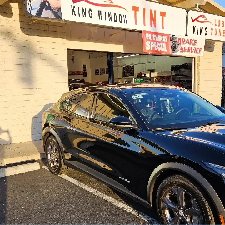 Black Ford Mustang Mach-E with freshly tinted windows, in the King Window Tint parking lot on Fulton Avenue, Sacramento