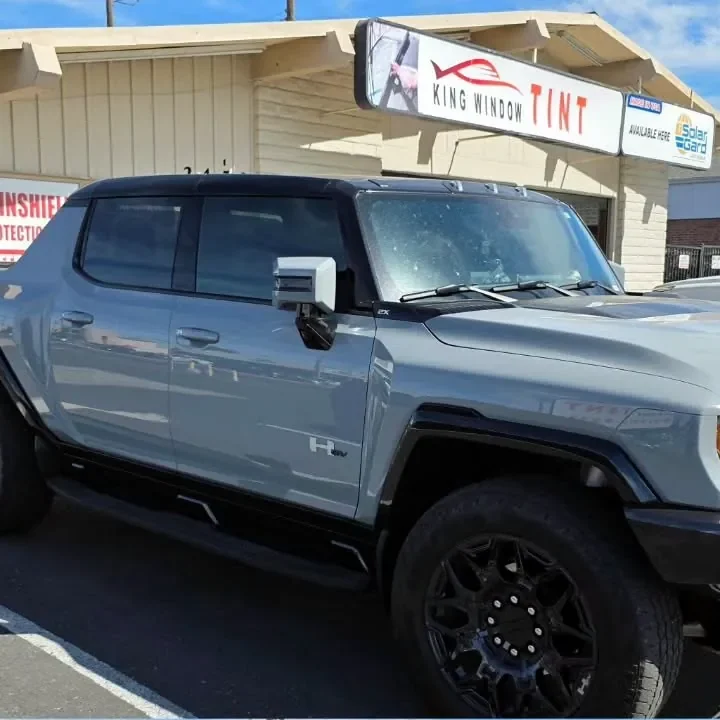 Gray GMC Hummer EV Pickup with freshly tinted windows, in the King Window Tint parking lot on Fulton Avenue, Sacramento