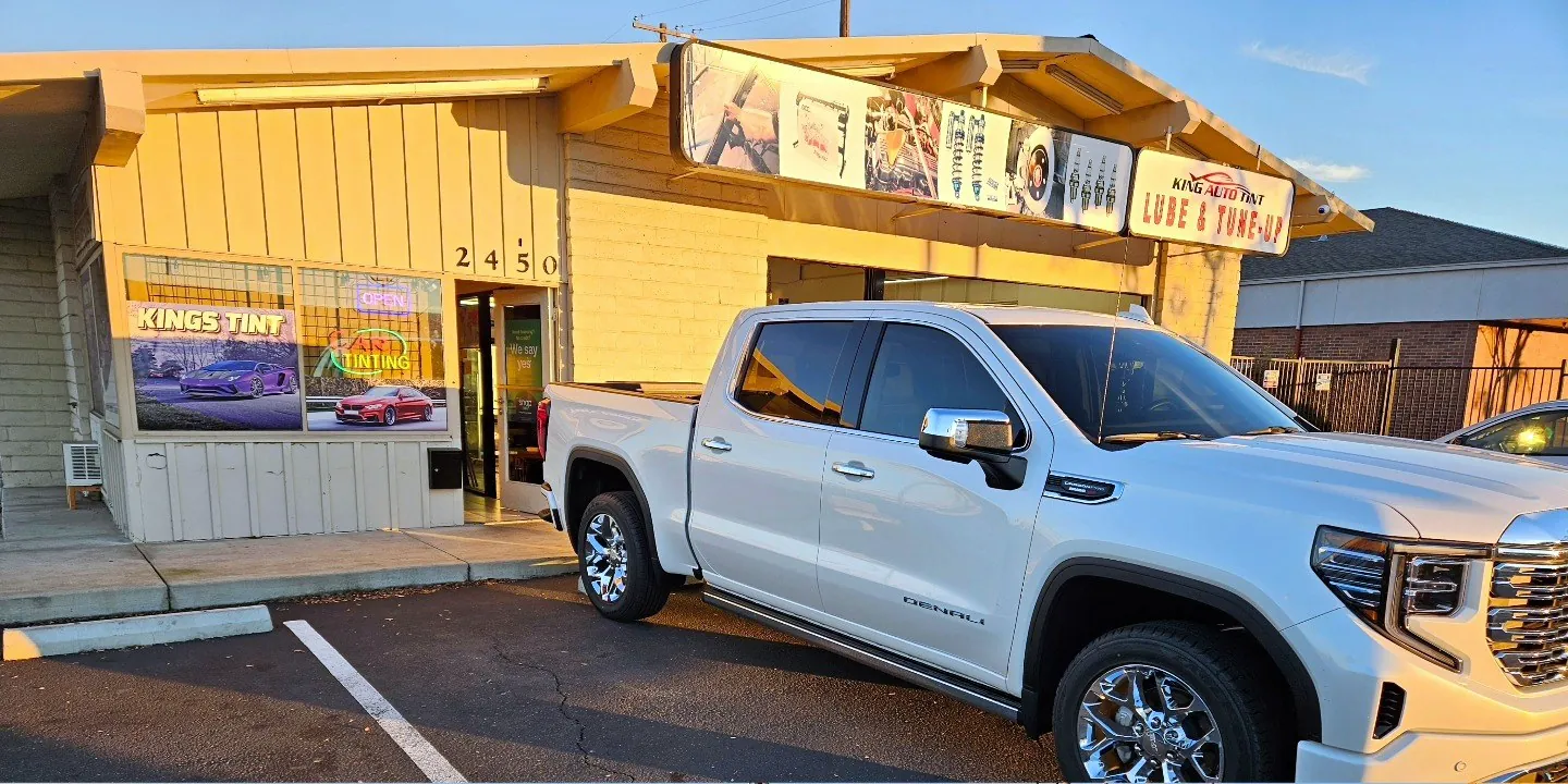 White GMC Sierra 1500 Denali with freshly tinted windows, in the King Auto Tint parking lot on Fulton Avenue, Sacramento