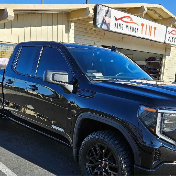 Black GMC Sierra 1500 with freshly tinted windows, outside the King Window Tint shop on Fulton Ave in Sacramento
