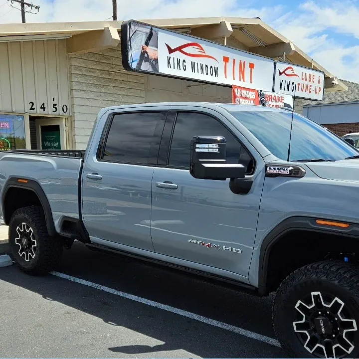 Gray GMC Sierra 2500HD AT4X with freshly tinted windows, photographed after its tint job at King Window Tint in Sacramento