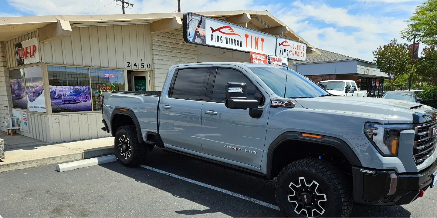 Gray GMC Sierra 2500HD AT4X with freshly tinted windows, photographed after its tint job at King Window Tint in Sacramento